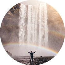 Man celebrating waterfall rainbow- Jared Erondu unsplash photo 210circ